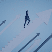 A professional woman ascending a staircase of success with upward-pointing arrows, symbolizing strategic career advancement as discussed in Measured Ability's blog post on maximizing career growth for job seekers.