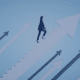 A professional woman ascending a staircase of success with upward-pointing arrows, symbolizing strategic career advancement as discussed in Measured Ability's blog post on maximizing career growth for job seekers.