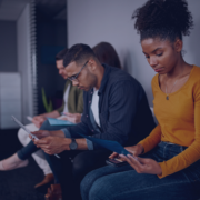 A group of South African jobseekers focused on their materials while waiting for interviews, exemplifying the proactive preparation strategies outlined in Measured Ability's guide for seasonal job applications