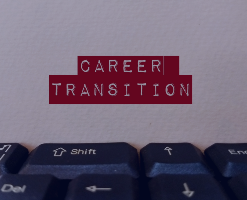 Close-up of a keyboard with a card labeled CAREER TRANSITION, symbolizing job seekers' end-of-year career change strategies