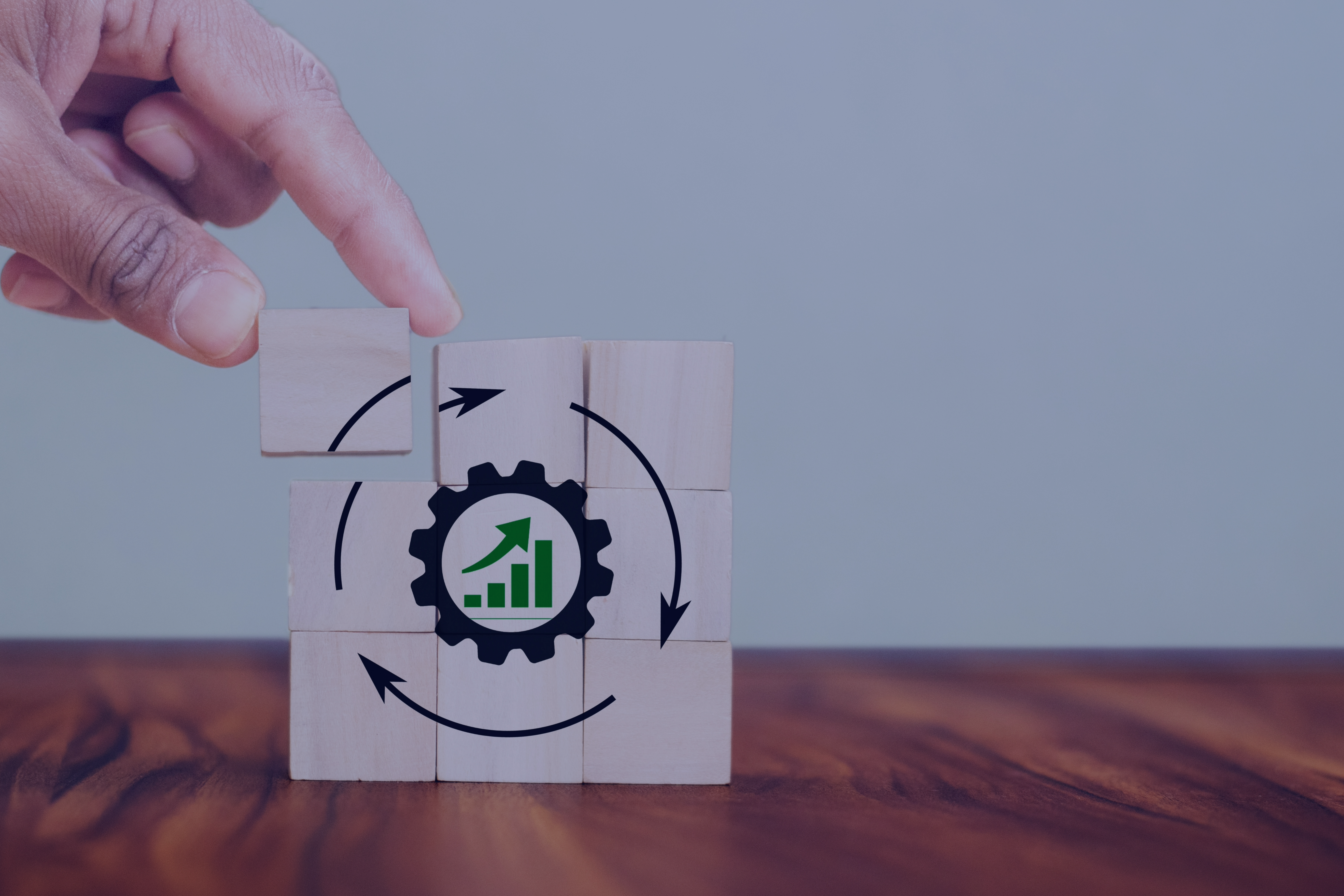 Hand placing the final piece in a puzzle depicting a gear with a growth graph, representing the continuous process of staffing and navigating the job market dynamics in South Africa.