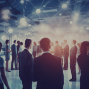 Group of finance professionals networking in a corporate event, connecting and exchanging information, illustrating the essential networking skills for job seekers in the finance sector."