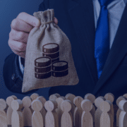 A concept image depicting a hand holding a money bag with coin stacks symbolizing budget allocation over a group of wooden figures representing staffing in startups