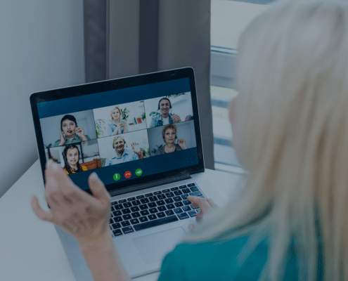 A woman participating in an online consulting meeting with multiple colleagues, reflecting the shift towards remote work in the consulting industry.