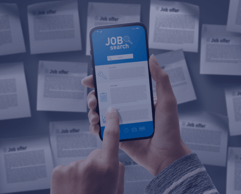 Hand holding a smartphone with a job search application on the screen amidst scattered job offer papers, representing online job-seeking strategies in South Africa