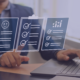 Business professional using a laptop with virtual checklists, symbolizing the role of payroll services in enhancing employee satisfaction through efficient task management.